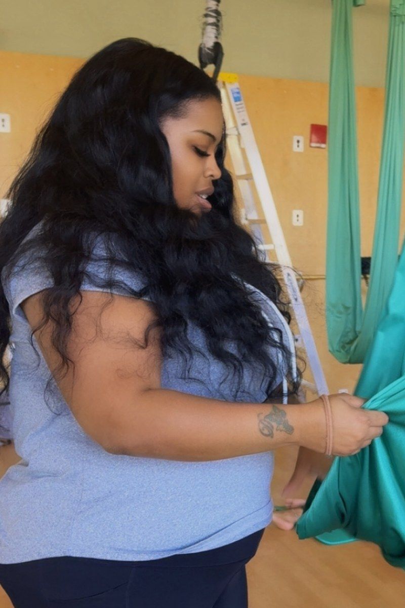 Before photo of @jasminbadd, standing in profile indoors in a light blue tee shirt.