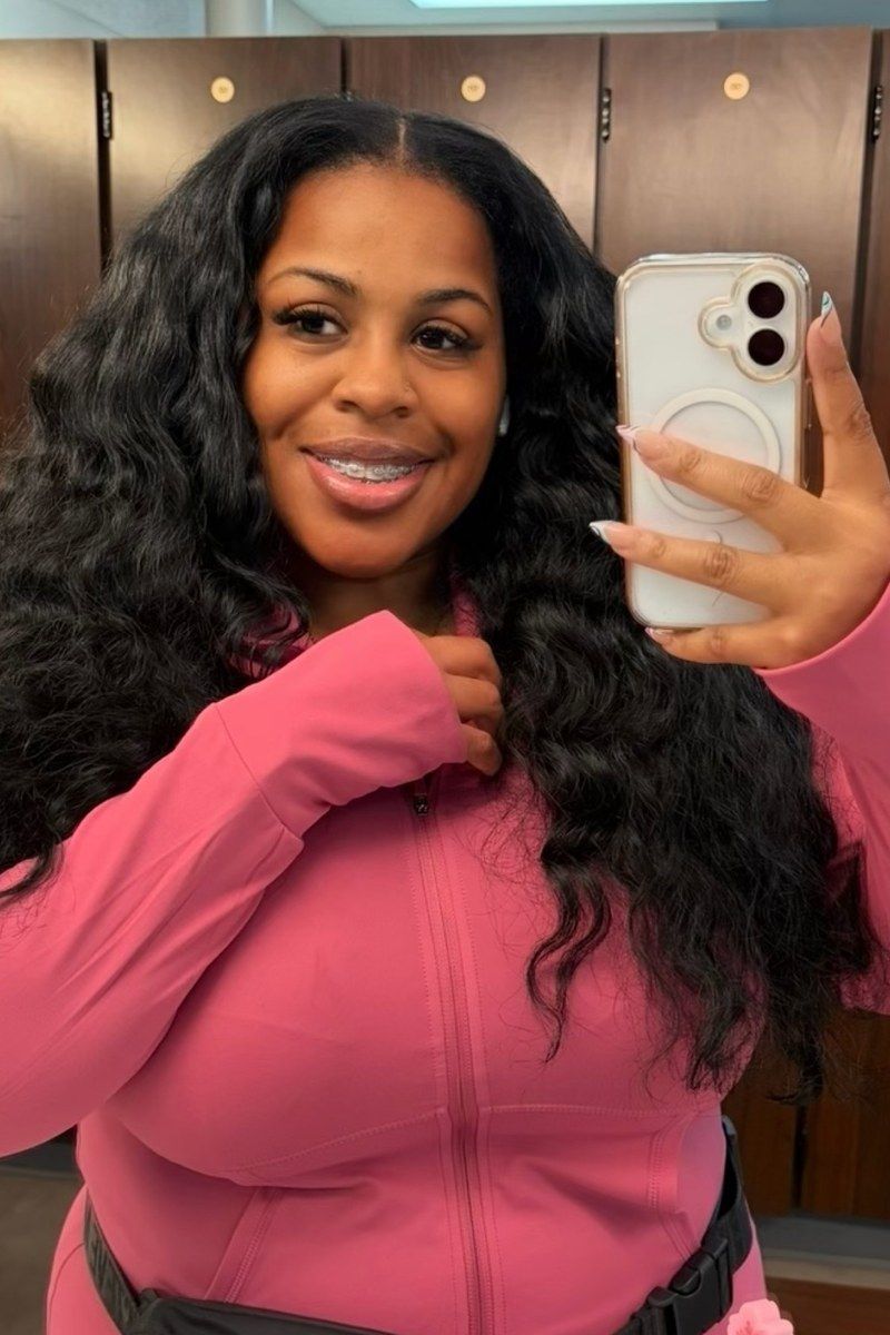 Before photo of @jasminbadd, a mirror selfie in a locker room in a pink zip up jacket.