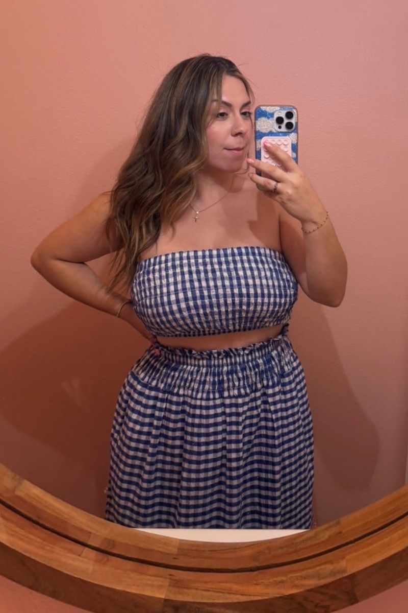 Before photo of @_tamaracorona, a mirror selfie in a blue gingham two piece in front of a round mirror.